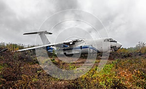 Large broken airliner on a field
