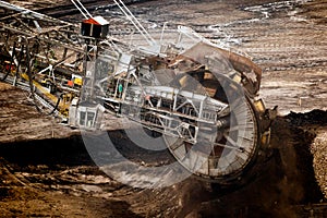 Large bucket wheel excavator mining machine at work in a brown coal open pit mine