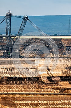 Large bucket wheel excavator mining machine at work in a brown coal open pit mine