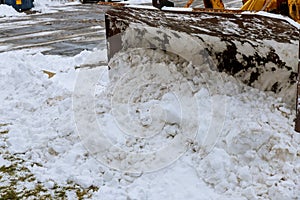 Large bucket wheel excavator for snow removal on a snowy parking lot after a blizzard