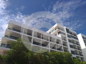 The large building with blue sky cloud and tree