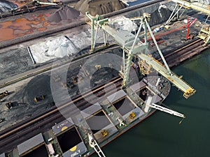 A large bulk carrier supplying iron-ore in a harbor