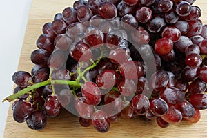 The large bunch of ripe red grapes