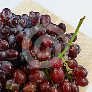 The large bunch of ripe red grapes