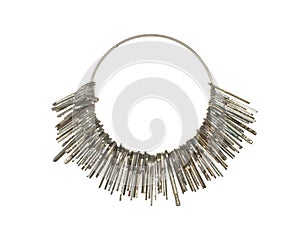 Large bunch of various keys on a metal ring isolated on a white