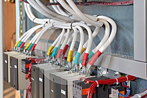 A large bundle of electrical cables or wires connected to contactors.