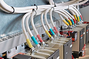 A large bundle of electrical cables or wires connected to contactors.