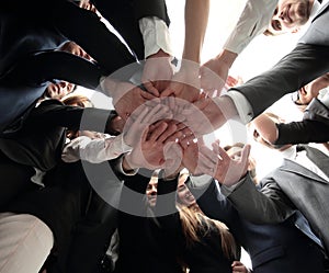 Large business team is forming a circle and his hands clasped together