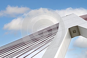 A large cable-stayed bridge on the German motorway over the river Rhine, against the blue sky, view from the bottom of the pillar.