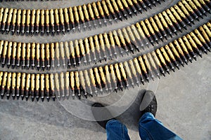 Large-caliber machine gun shells lie on the asphalt. View from above