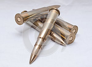 Large caliber rifle bullets on a white background