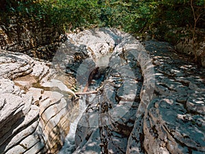 Large canyons covered with moss and forest with a river flowing between them in a narrow gorge