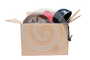 A large cardboard box filled with Yard Sale or Tag Sale items to be sold at a discount in order to make room and make some money