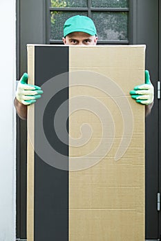 Large cardboard box in the hands of a courier delivery man. Delivery package to the address.