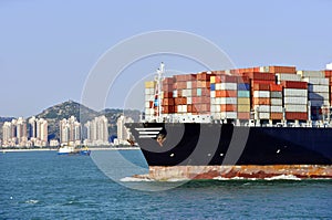 Large cargo container ship, fully loaded with boxes.
