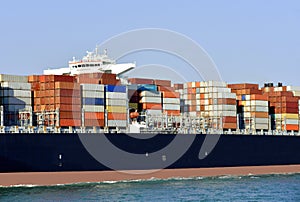 Large cargo container ship, fully loaded with boxes.