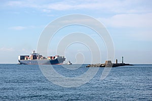 Large cargo container ship in harbor of Livorno, Italy