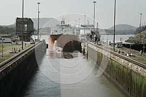 Large cargo ship entering Miraflores Locks at Panama Canal