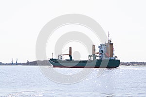 A large cargo ship enters the port