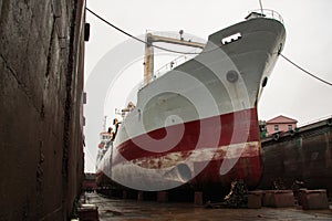 a large cargo ship or freighter docked at a shipyard