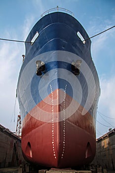 a large cargo ship or freighter docked at a shipyard