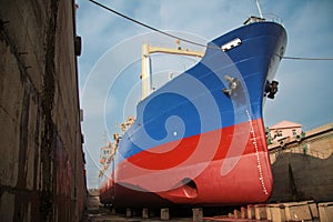 a large cargo ship or freighter docked at a shipyard