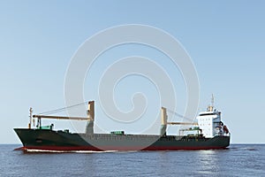 A large cargo ship is sailing at sea