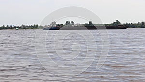 Large cargo ship sails on river