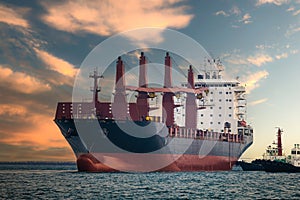 large carrier ship floating afternoon in sea, tugboat dragging container ship, blue sky evening background and sea front