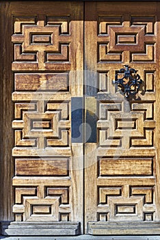 Large carved wooden doors signify entryway into old buildng