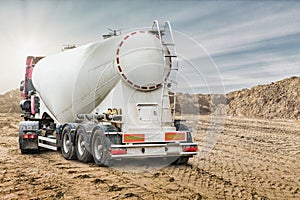 A large cement truck brought cement to the construction site. Powerful modern construction equipment. Delivery and transportation