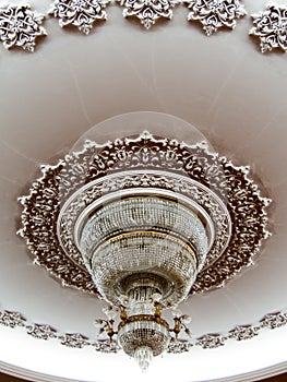 Large chandelier on nicely decorated ceiling