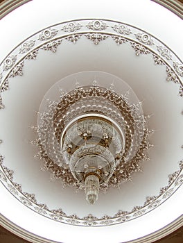 Large chandelier on nicely decorated ceiling