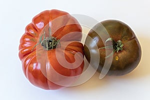 Large Cherokee purple and Montserrat type organic heirloom tomatoes isolated on white