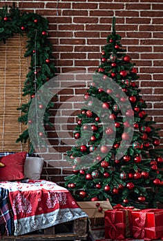 Large Christmas tree with red Christmas balls in the interior of the room.