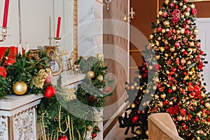 Large Christmas tree with red and gold balls and fireplace