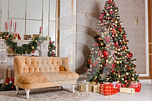 Large Christmas tree with red and gold balls and fireplace indoors