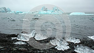 Large chunk of ice and pure blue iceberg in foggy glacier lagoon, Icelandic nature misty weather, 8k 4:2:2 10 bit