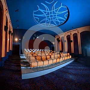 Large cinema theater with empty chair movie seats.