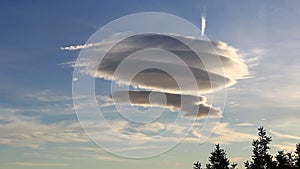 Large circular clouds Altocumulus lenticularis duplicatus in the sky