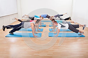 Large class of people working out in a gym