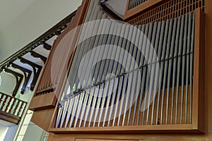 A large classical organ inside the Catholic Church. a keyboard wind musical instrument. Pipe organ close-up