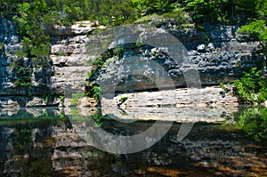 Large Cliff reflecting Arkansas Calm River