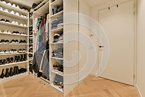 a large closet filled with shoes and a white door