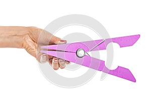 Large clothes pin in his hand.