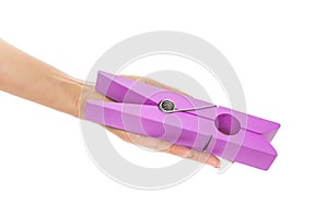 Large clothes pin in his hand.