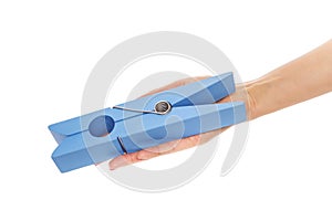 Large clothes pin in his hand.