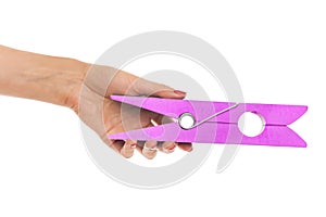 Large clothes pin in his hand.