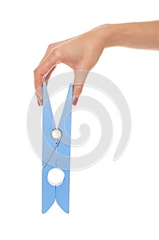 Large clothes pin in his hand.