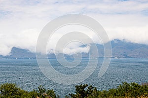 large cloud over mountain shore of Lake Sevan